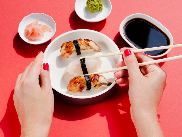 Woman holding a plate with sushi