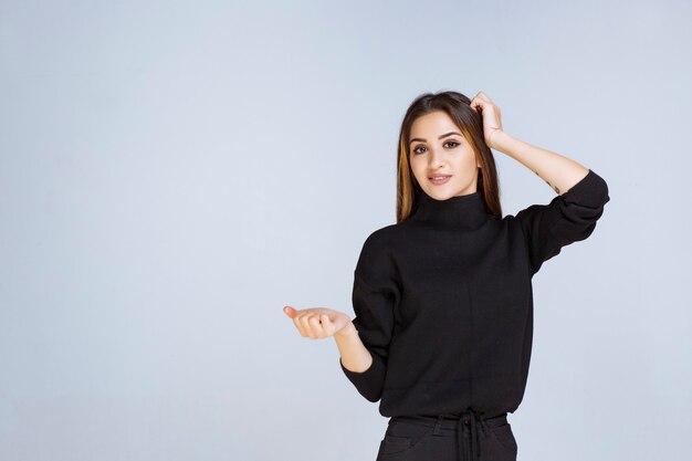 woman holding and presenting something in her palm. 