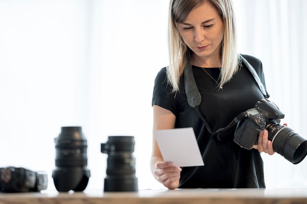 Woman holding a professional camera and photo