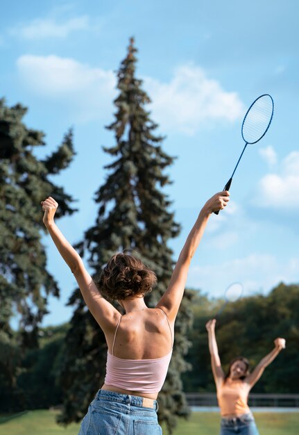 Woman holding racket back view