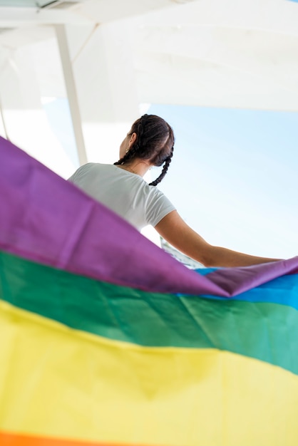 Free photo woman holding rainbow flag