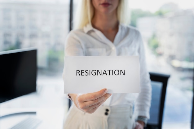 Woman holding resignation letter front view