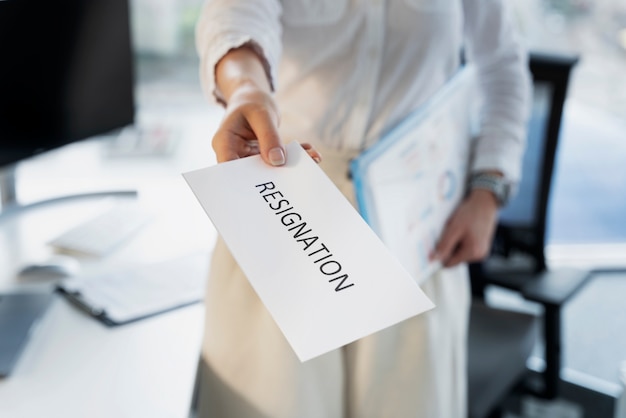 Woman holding resignation letter high angle