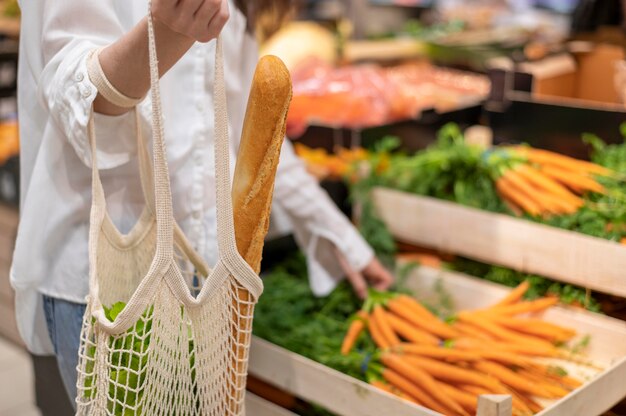 Woman holding reusable bag in grocery store