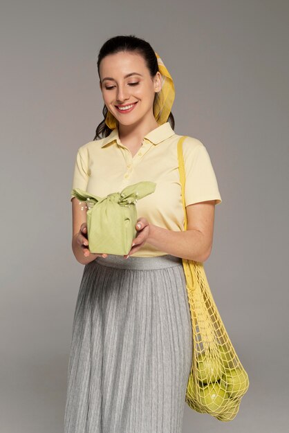 Woman holding reusable napking and turtle bag