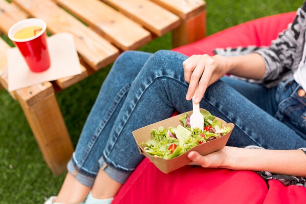 Woman holding a salad and a fork