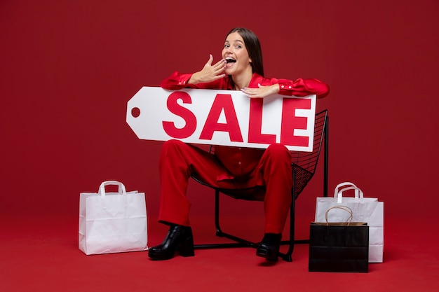 Woman holding sale tag full shot Free Photo