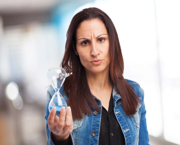 woman holding a sand timer