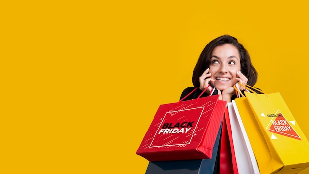 Woman holding shopping bags with copy space