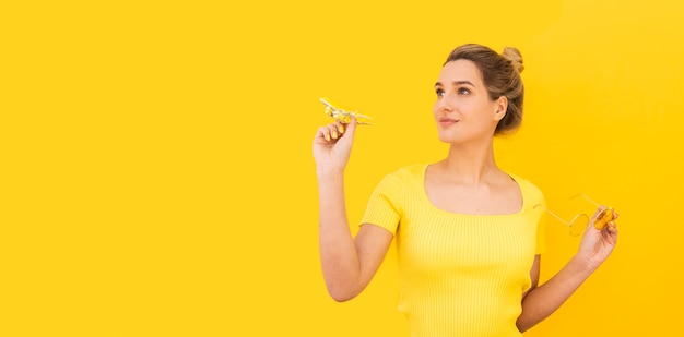 Woman holding small airplane