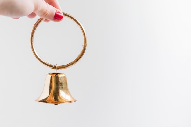 Free photo woman holding small bell in hand