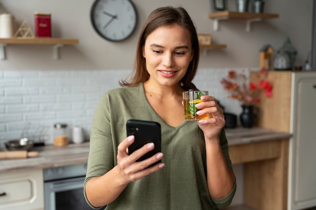 Woman holding smartphone front view