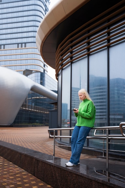 Woman holding smartphone full shot