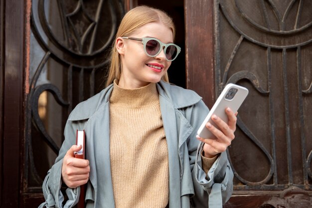 Woman holding smartphone medium shot