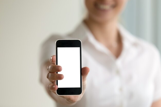 Woman holding smartphone, mockup screen for mobile ads, copy space