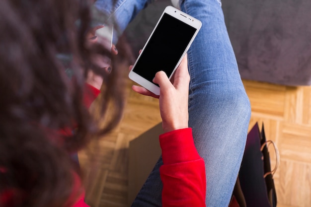 Free photo woman holding smartphone