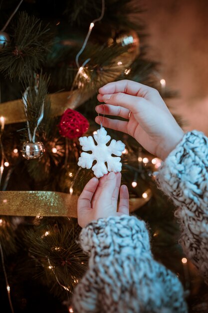 Woman holding snowflake in hand 