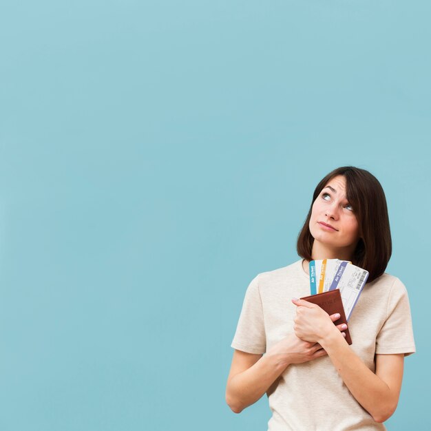 Woman holding some airplane tickets with copy space