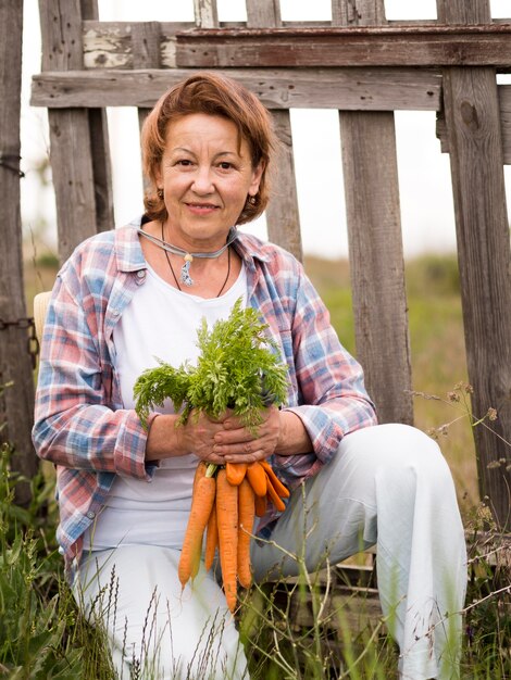 Woman holding some carrots in her hand