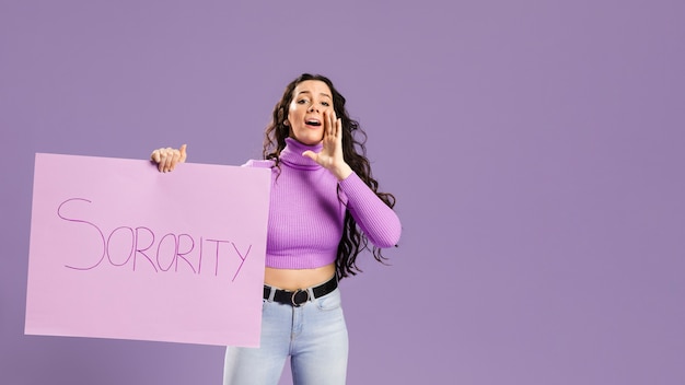 Woman holding sorority cardboard and shouting