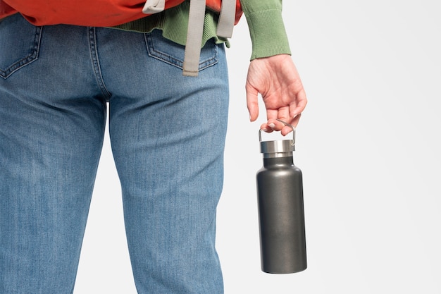 Woman holding a stainless steel water bottle