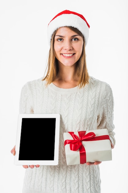 Woman holding tablet and gift box 