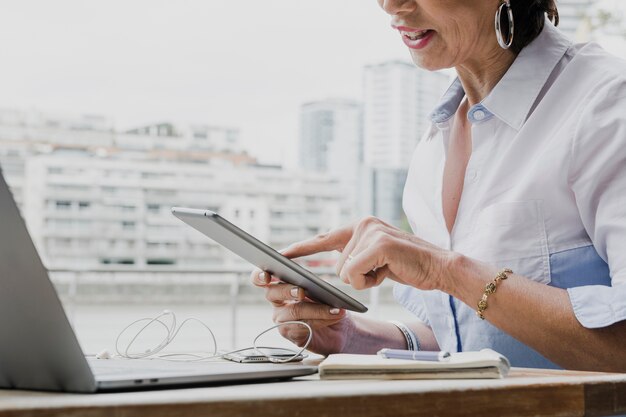 Woman holding a tablet in her office