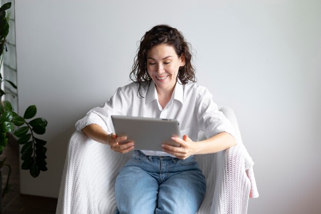 Woman holding tablet medium shot