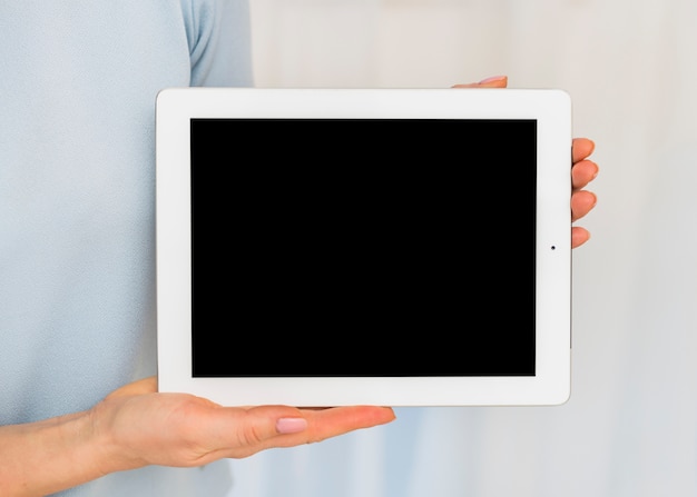 Woman holding tablet with black blank screen