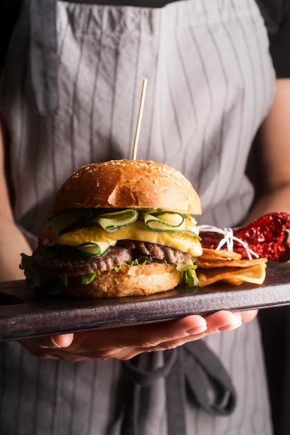 ハンバーガーとおいしい食事を保持している女性