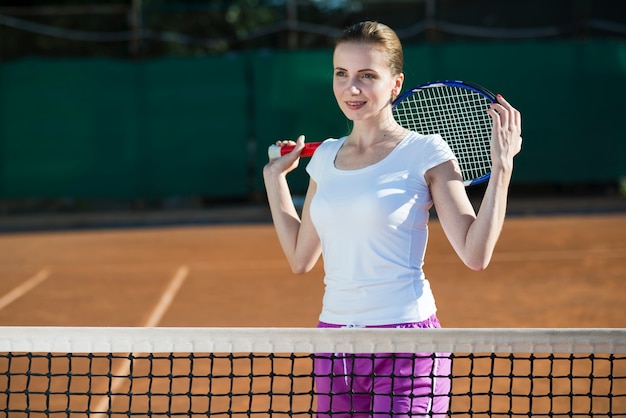 Woman holding tennis racket on the back
