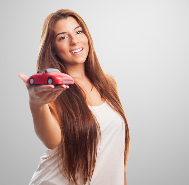 Woman holding toy car. 