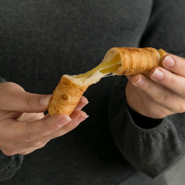 Woman holding traditional tequenos dish