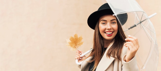 Woman holding a transparent umbrella with copy space