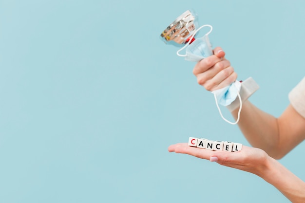 Woman holding a trophy and a medical mask