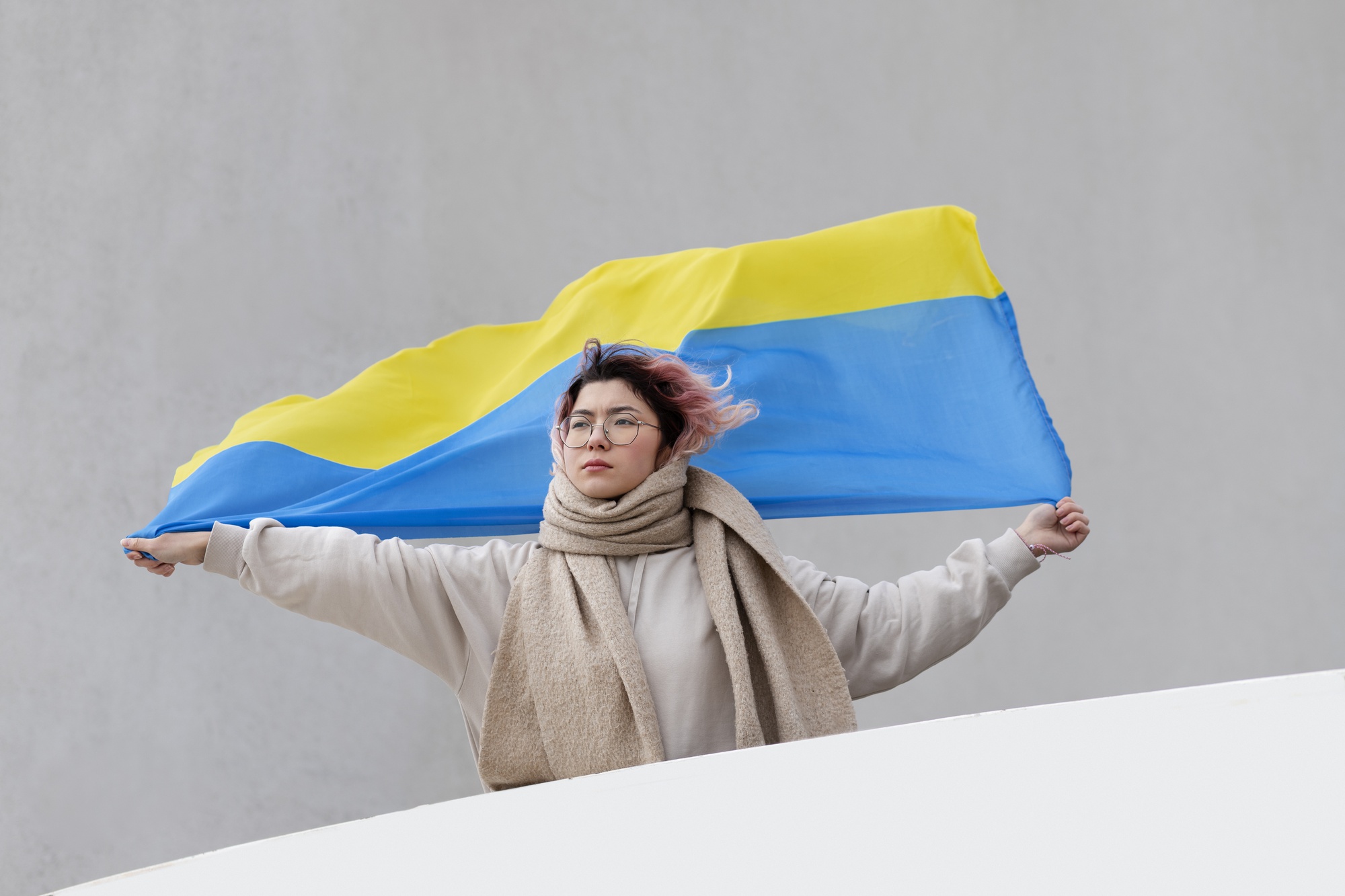 Woman holding ukrainian flag medium shot