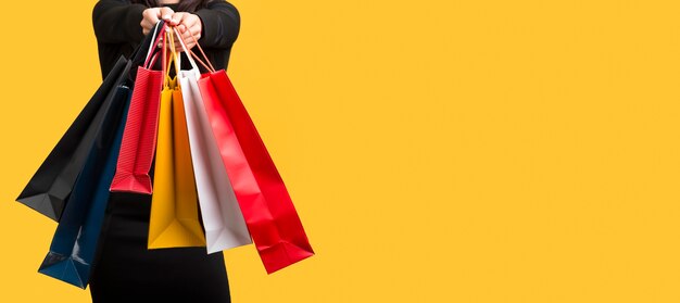 Woman holding various shopping bags copy space