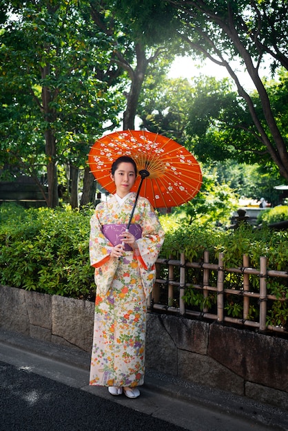 Woman holding wagasa umbrella full shot