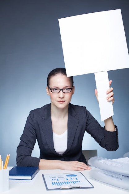 Woman holding a white sign