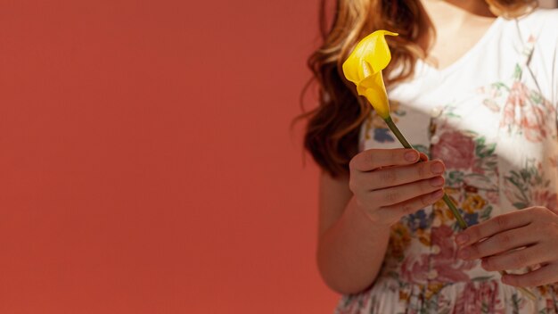 Woman holding yellow calla lily