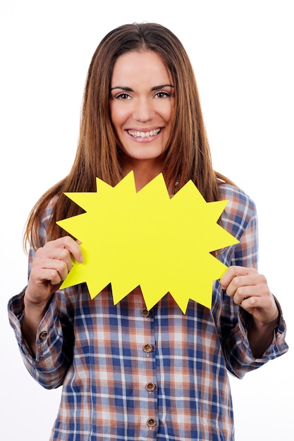 Free photo woman holding yellow panel isolated on white background