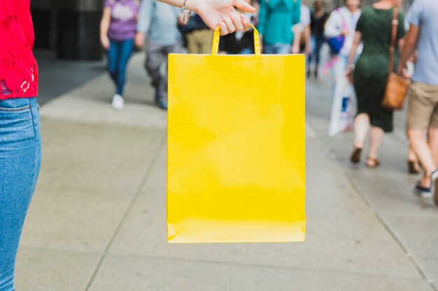 Woman holding yellow shopping bag