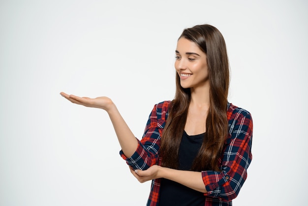 Beautiful Woman holding your product over copy space – Free Stock Photos