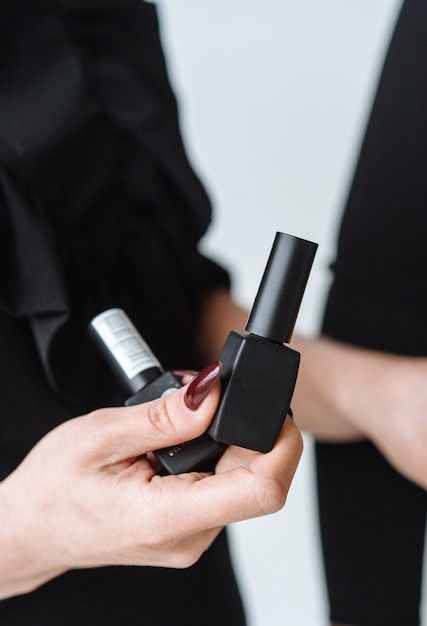 Woman holds black mascara in her hand