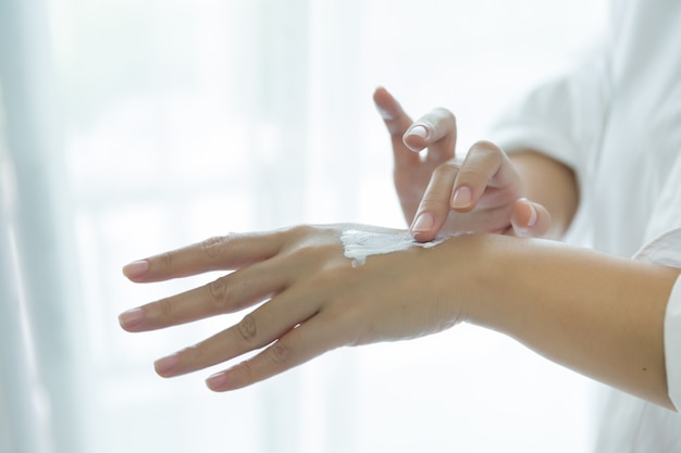 woman holds a jar with a cosmetic cream in her hands