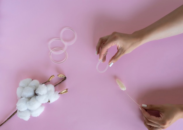 A woman holds a vaginal ring in her hands for contraception purposes