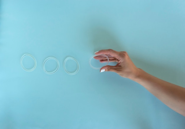 A woman holds a vaginal ring in her hands for contraception purposes