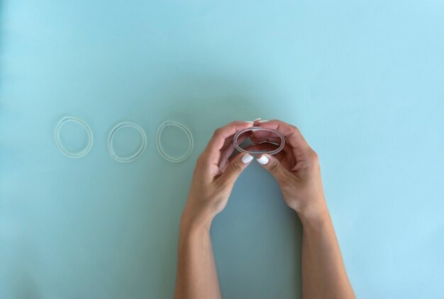 A woman holds a vaginal ring in her hands for contraception purposes