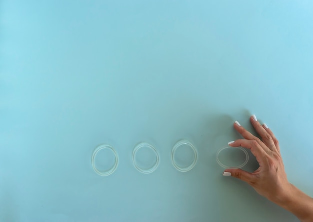 A woman holds a vaginal ring in her hands for contraception purposes