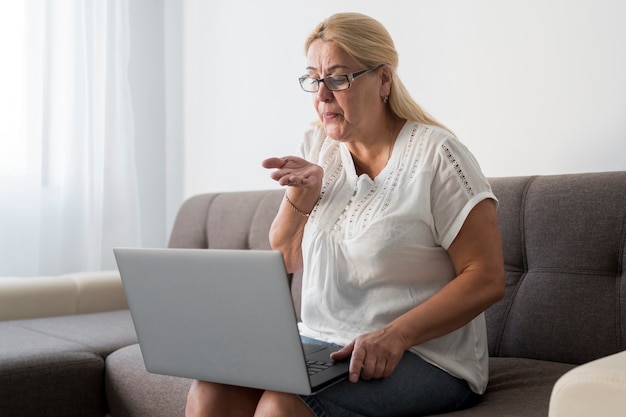 Woman at home in quarantine having a video call with friends